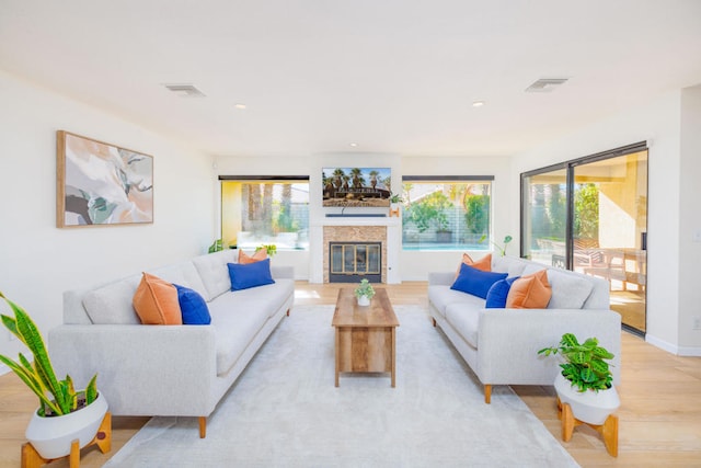 living room with a wealth of natural light and light wood-type flooring