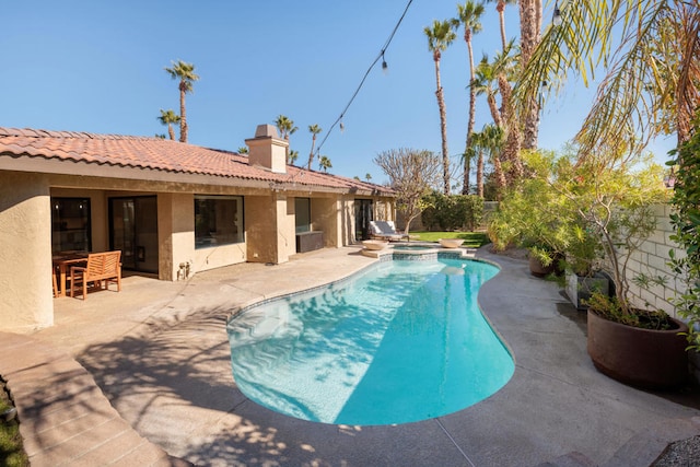 view of pool with a patio area and an in ground hot tub