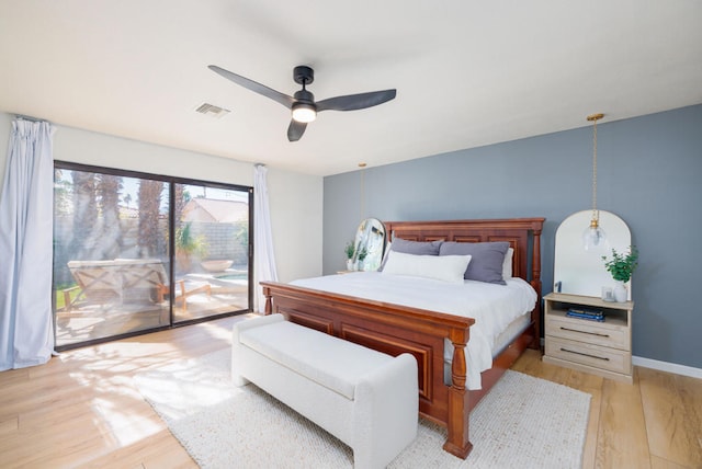 bedroom featuring ceiling fan, light hardwood / wood-style flooring, and access to outside