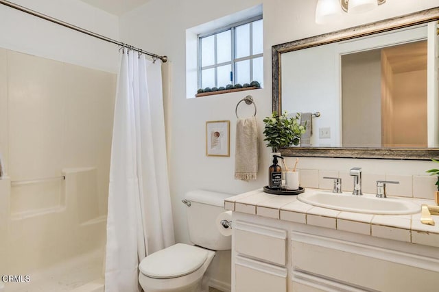 bathroom featuring vanity, toilet, and walk in shower