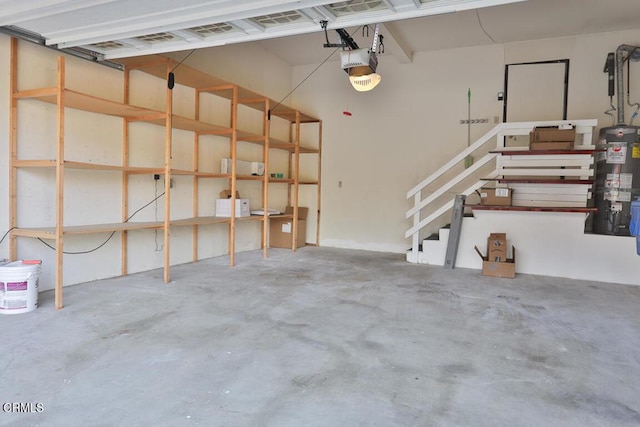 garage featuring a garage door opener and water heater