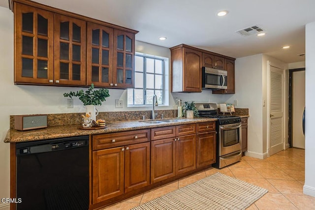 kitchen featuring sink, stainless steel appliances, and light tile patterned flooring