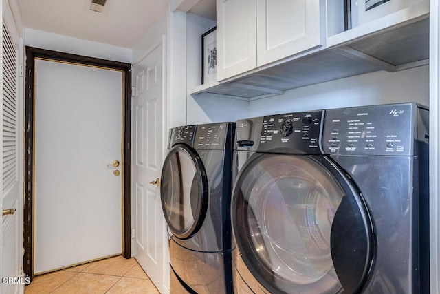 laundry area featuring cabinets, washer and clothes dryer, mail boxes, and light tile patterned floors