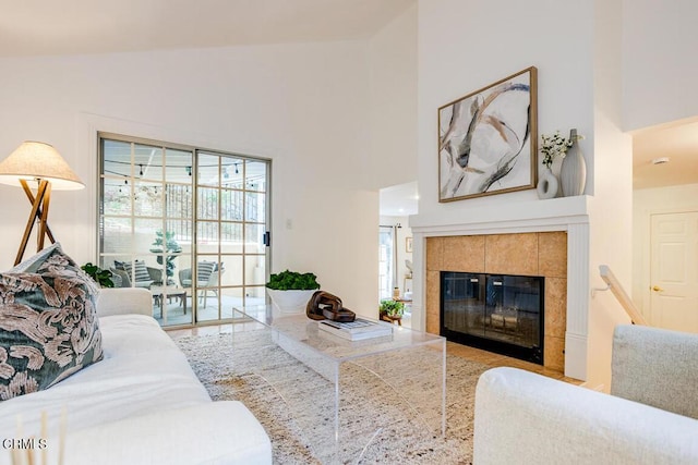 living room featuring high vaulted ceiling and a fireplace