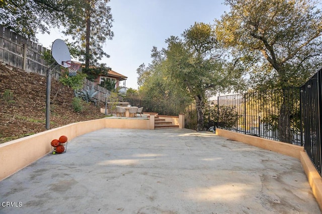 view of patio / terrace featuring basketball hoop