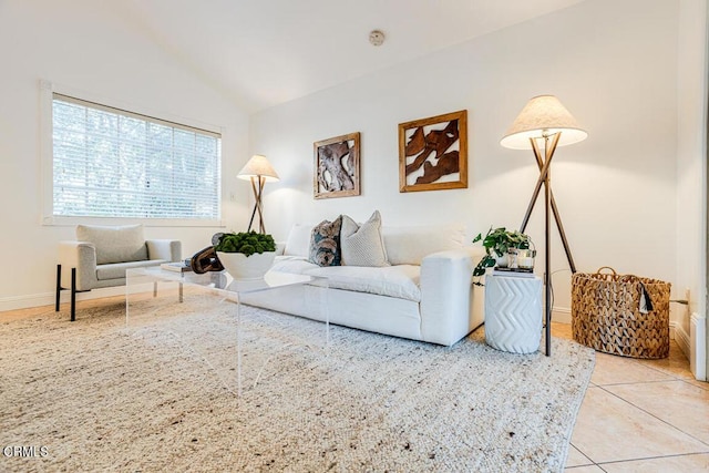 living room with vaulted ceiling and light tile patterned flooring