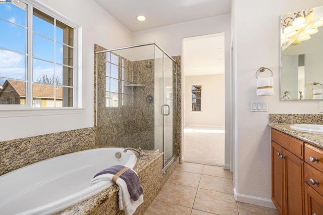 bathroom featuring vanity, tile patterned floors, and plus walk in shower