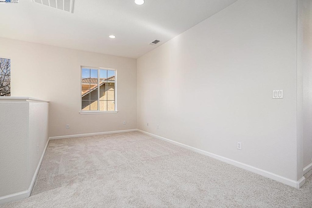 empty room featuring light colored carpet