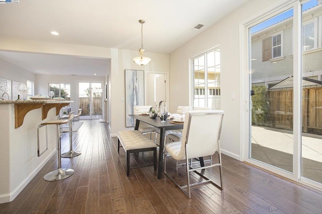 dining space with dark wood-type flooring