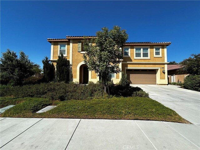 mediterranean / spanish house featuring a garage