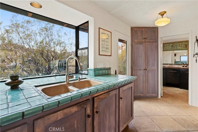 kitchen with tile counters and sink