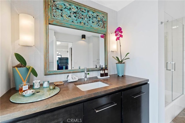 bathroom featuring vanity, tasteful backsplash, and enclosed tub / shower combo