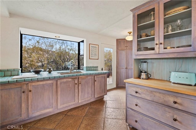 kitchen featuring sink and tile counters