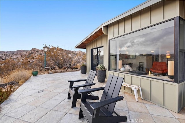 view of patio with exterior bar and a mountain view