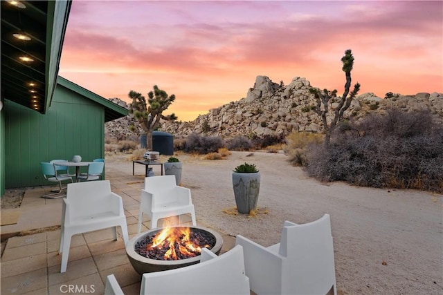 patio terrace at dusk with a fire pit