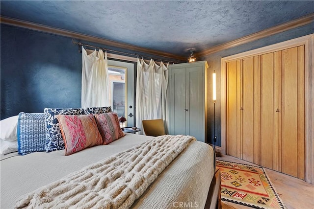 bedroom featuring crown molding, hardwood / wood-style floors, and a textured ceiling