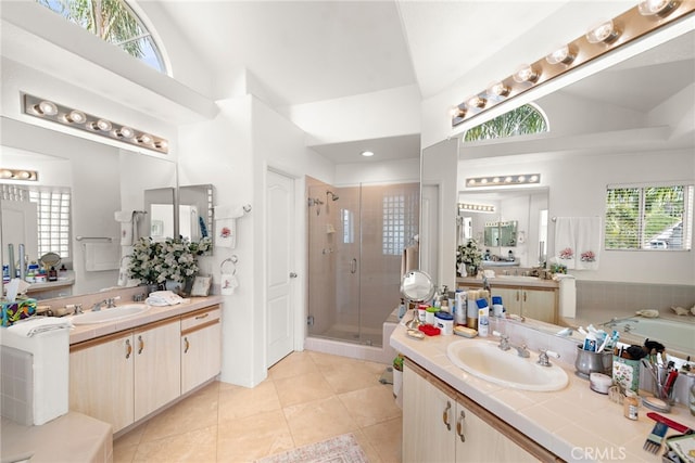 bathroom featuring high vaulted ceiling, independent shower and bath, tile patterned flooring, and a wealth of natural light