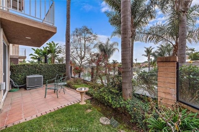 view of patio / terrace with cooling unit and a balcony