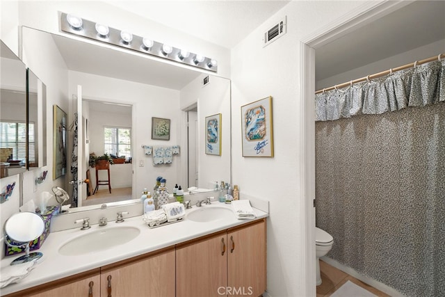 bathroom featuring vanity and toilet