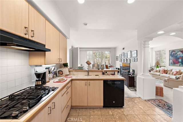 kitchen featuring light brown cabinetry, decorative columns, black appliances, sink, and kitchen peninsula