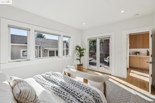 bedroom with wood-type flooring and access to outside