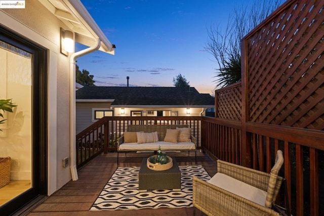 deck at dusk with outdoor lounge area