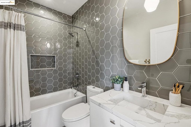 full bathroom with shower / bathtub combination with curtain, tile walls, vanity, tasteful backsplash, and toilet