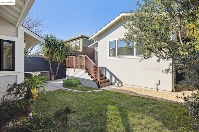 entrance to property with a lawn