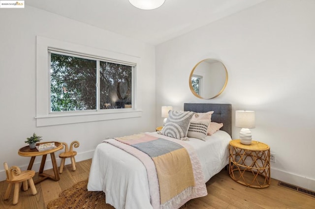 bedroom with hardwood / wood-style flooring