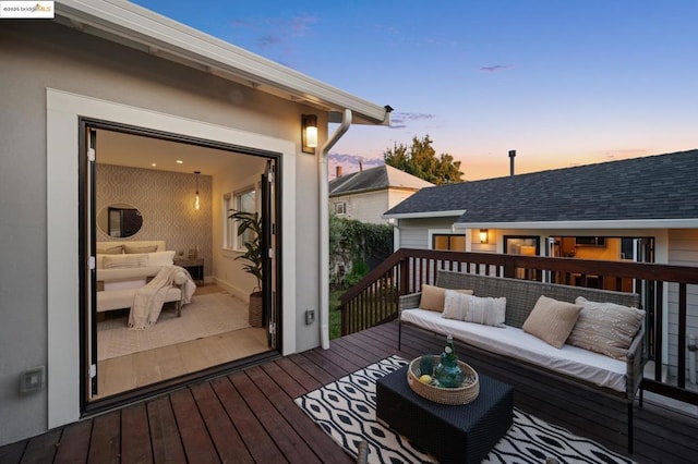 deck at dusk with an outdoor living space