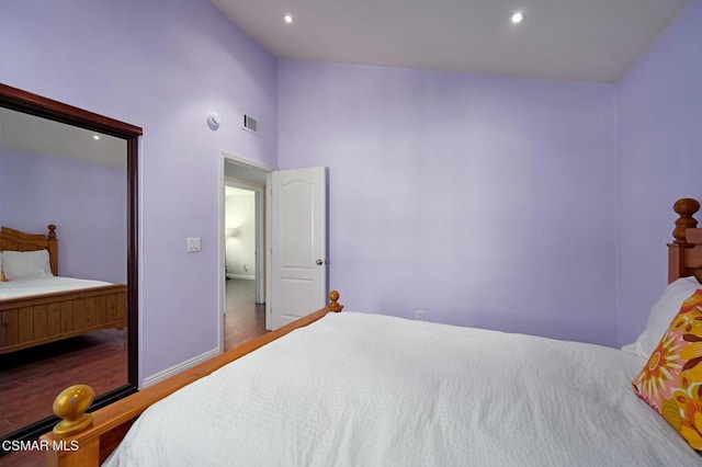 bedroom featuring wood-type flooring and lofted ceiling