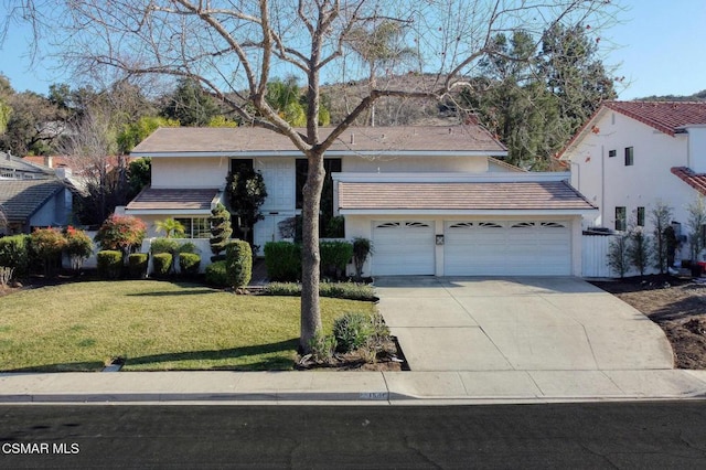 view of front facade featuring a garage and a front lawn