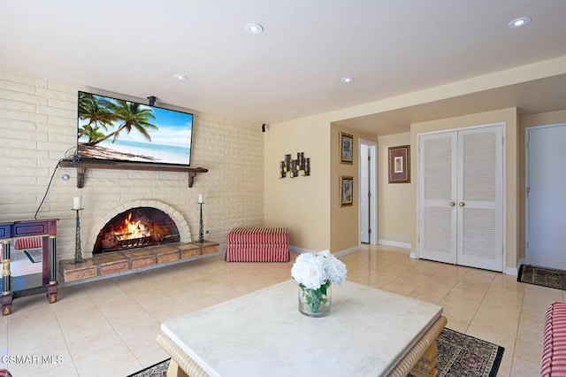 living room with a fireplace and light tile patterned floors