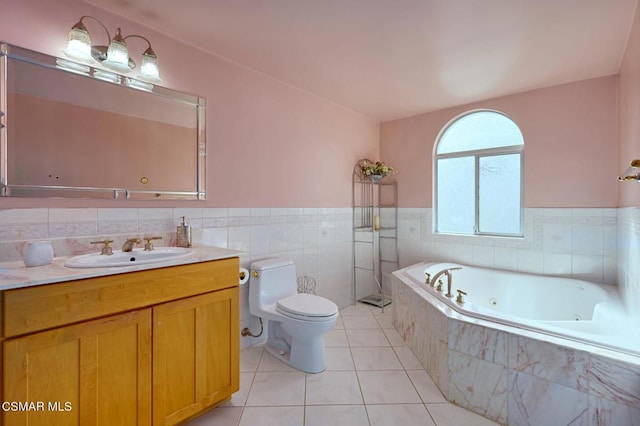 bathroom with tile walls, a relaxing tiled tub, vanity, tile patterned floors, and toilet