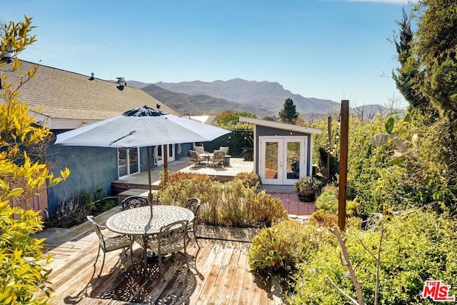 exterior space featuring french doors and a deck with mountain view