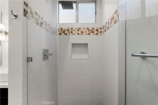 bathroom featuring a shower with door