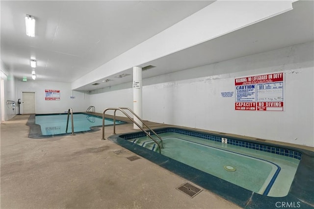 view of pool with an indoor hot tub