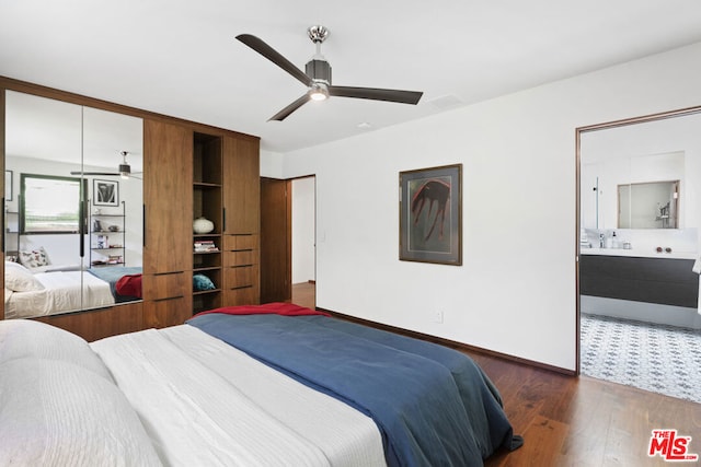 bedroom with dark wood-type flooring, ensuite bath, and ceiling fan