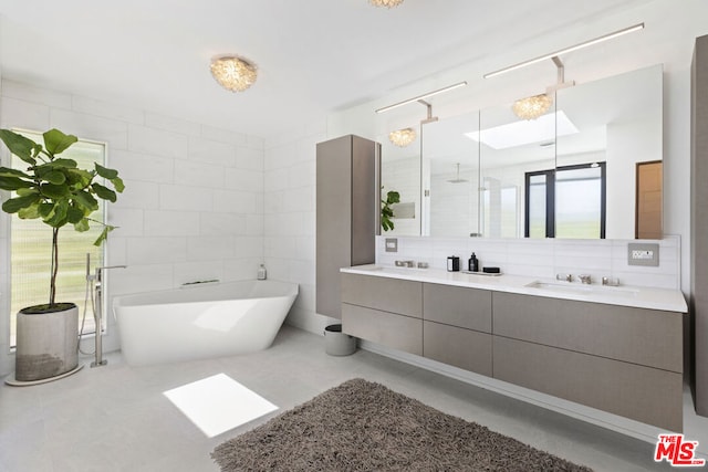 bathroom featuring tasteful backsplash, vanity, tile walls, and a tub to relax in