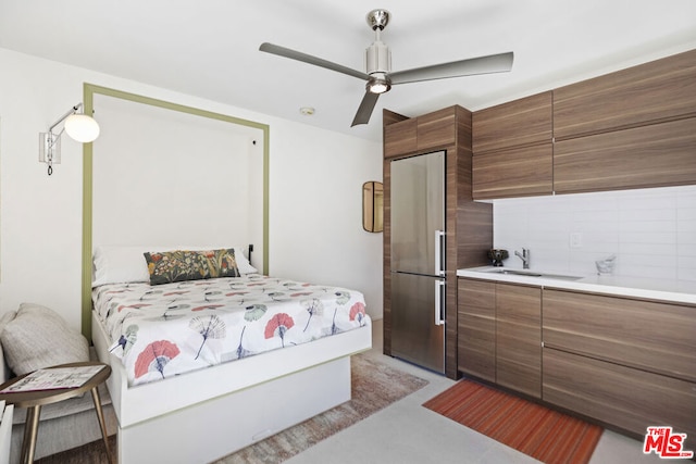 bedroom featuring sink, stainless steel refrigerator, and ceiling fan