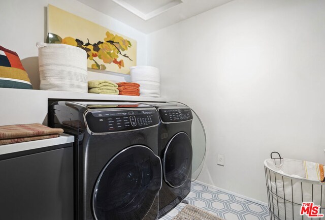 laundry area with washing machine and clothes dryer