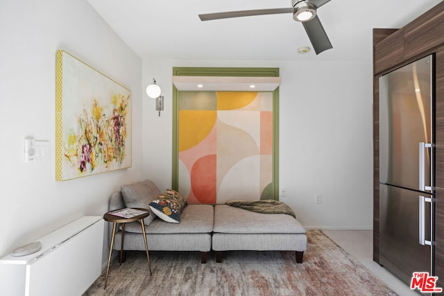 bedroom with stainless steel refrigerator and ceiling fan