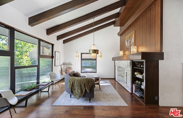 interior space with dark wood-type flooring, a fireplace, high vaulted ceiling, and beamed ceiling