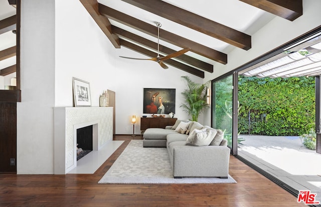 living room featuring ceiling fan, a high end fireplace, hardwood / wood-style floors, and vaulted ceiling with beams