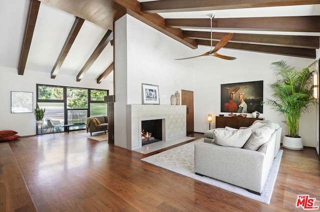 living room featuring beam ceiling, wood-type flooring, high vaulted ceiling, and ceiling fan