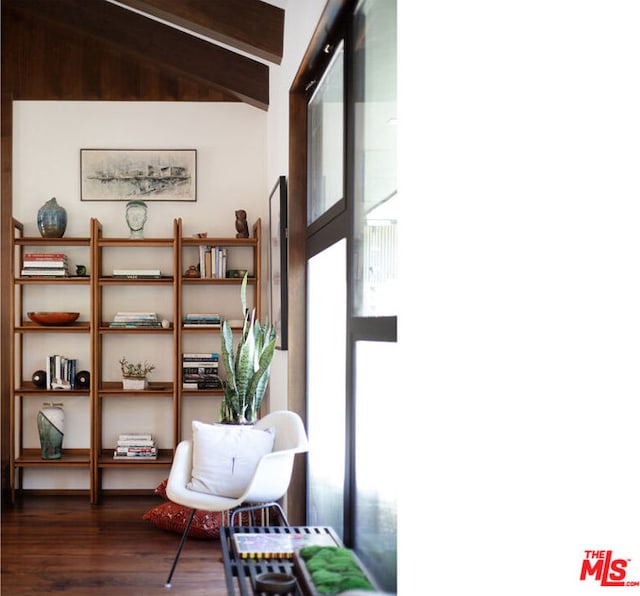 living area featuring lofted ceiling with beams and dark hardwood / wood-style flooring