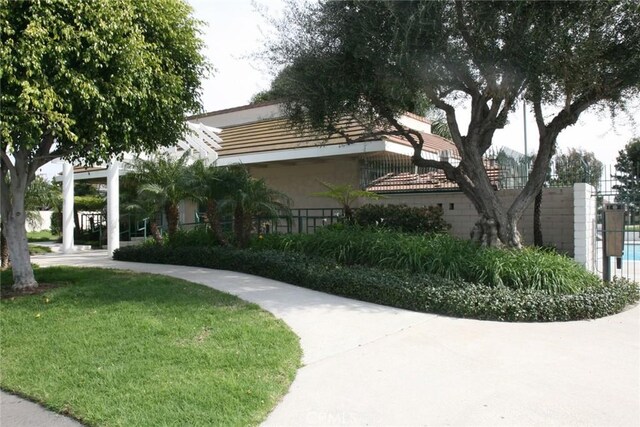 view of community with fence and a lawn