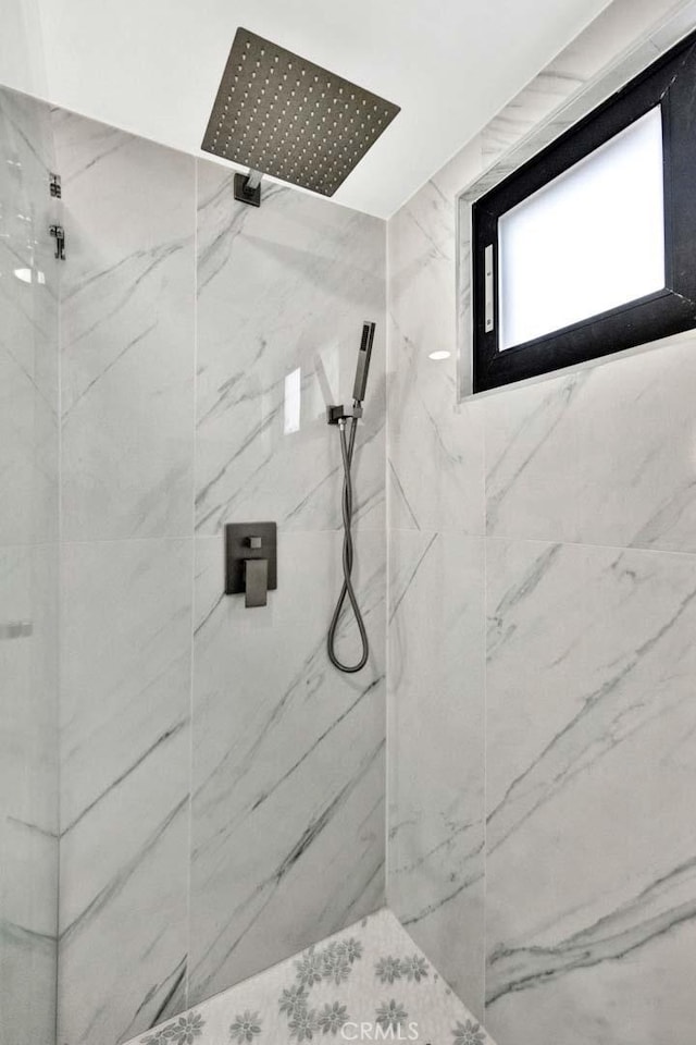 full bath with a marble finish shower