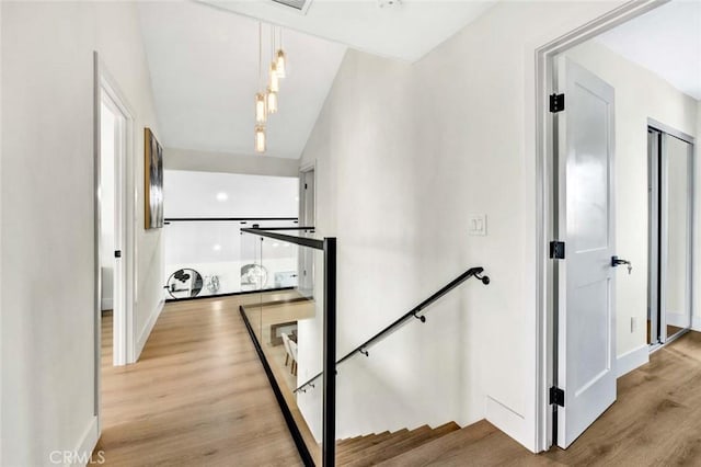 stairway with baseboards and wood finished floors