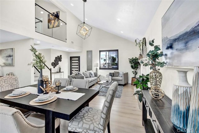 dining room featuring high vaulted ceiling, recessed lighting, and light wood finished floors